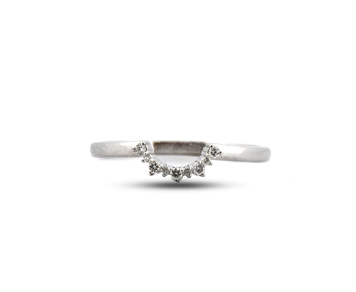 Silver ring with wavy design on a white background