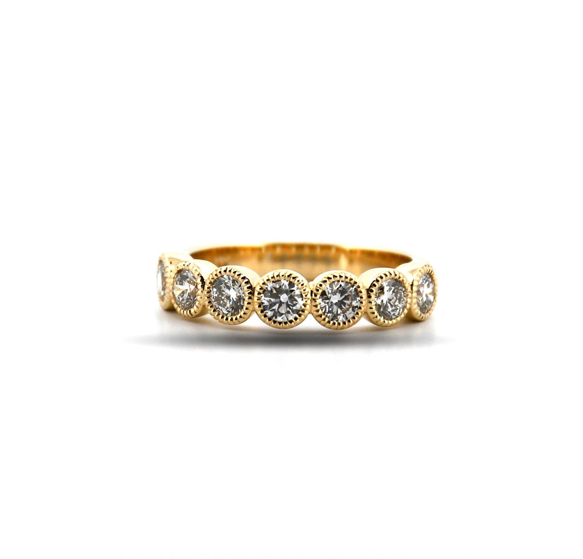 Gold ring with embedded diamonds on a white background