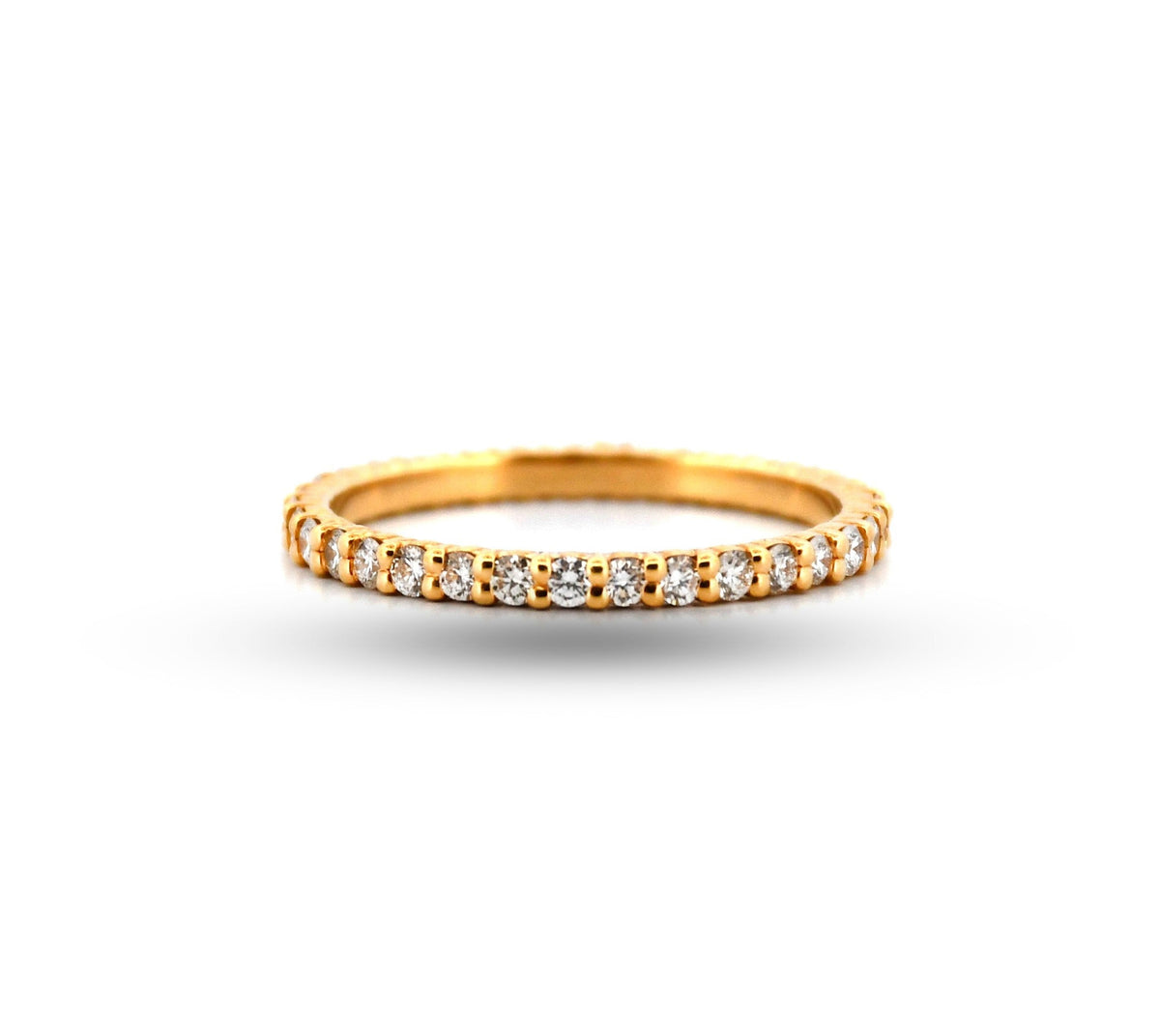 Gold ring with embedded diamonds on a white background