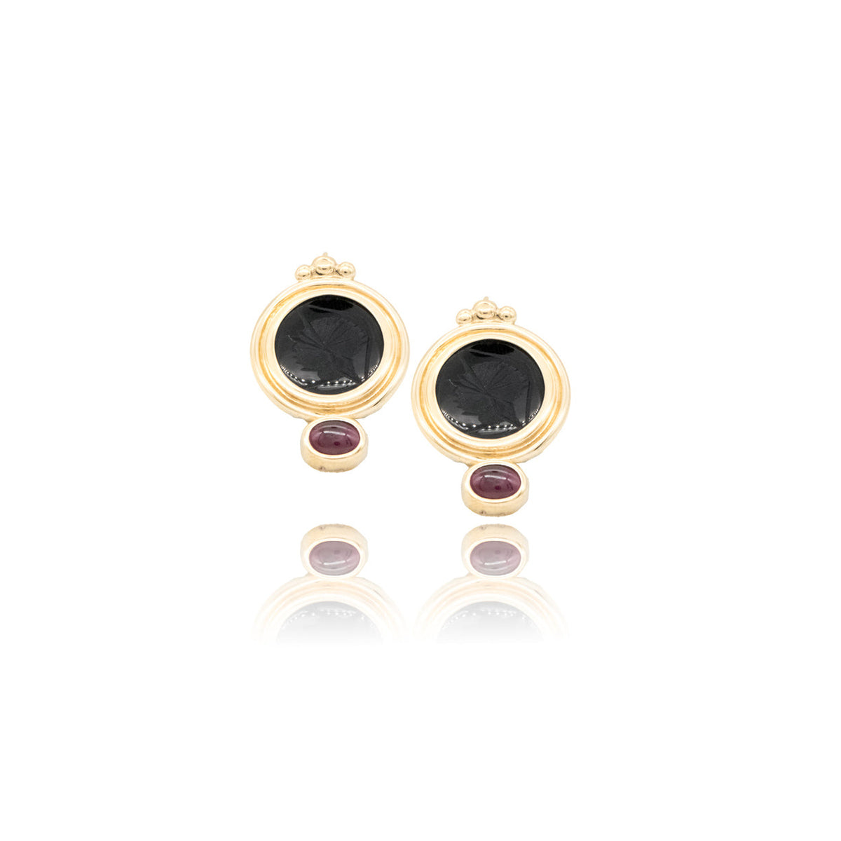 Gold earrings on a white background
