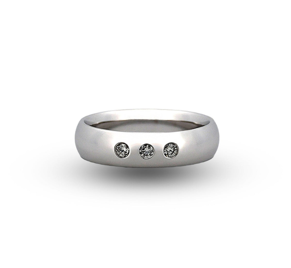 Silver ring with three diamonds on a white background