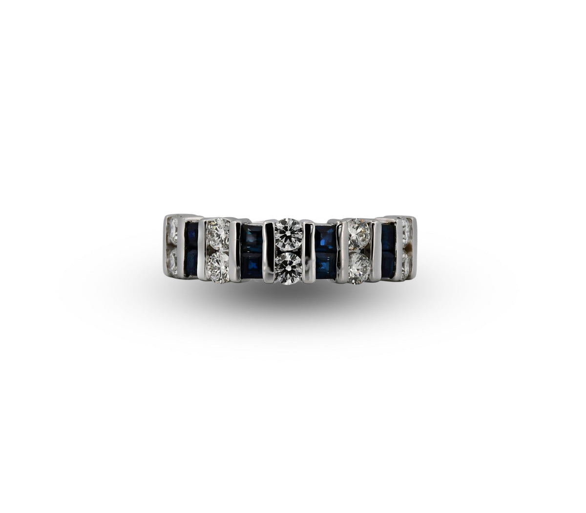 A vintage-style diamond and sapphire eternity ring in a silver-toned setting, featuring rectangular baguette-cut diamonds, round brilliant-cut diamonds, and deep blue sapphires, centered on a plain white background.