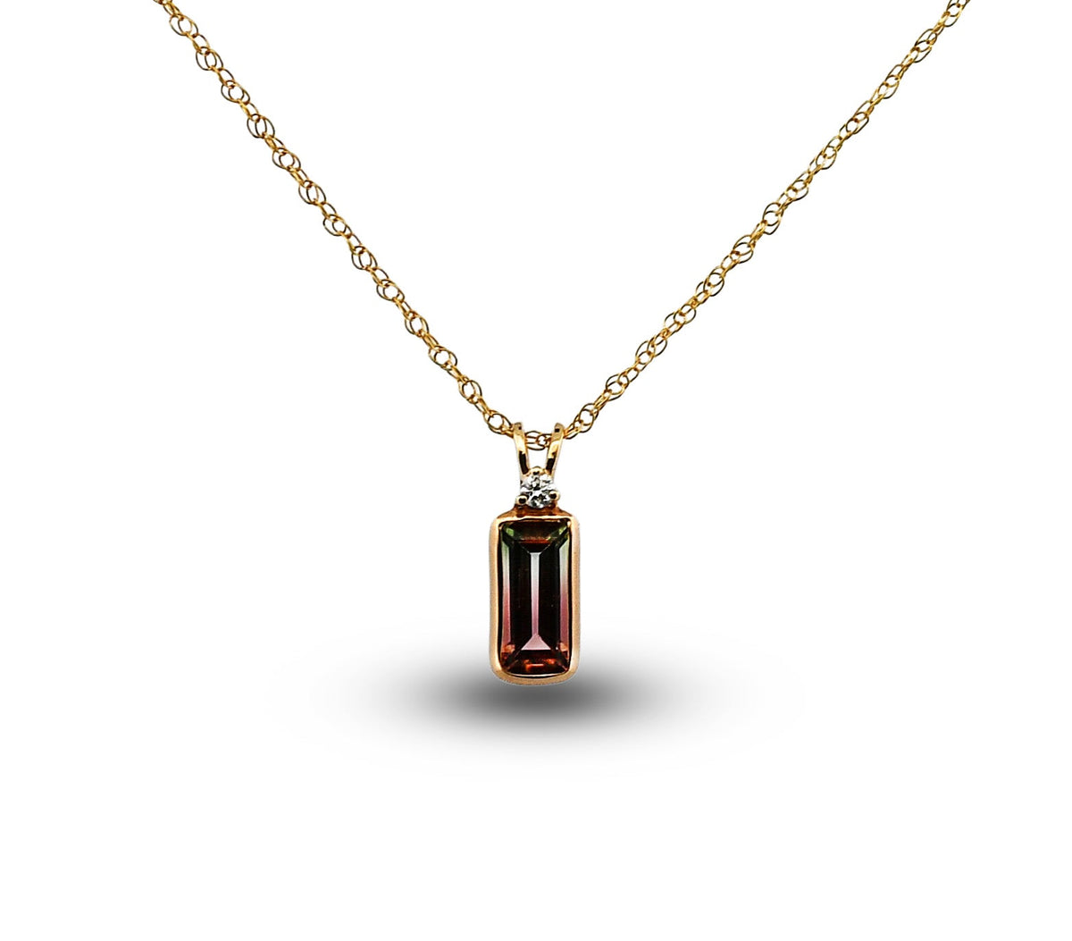 Gold necklace with a rectangular gemstone pendant on a white background