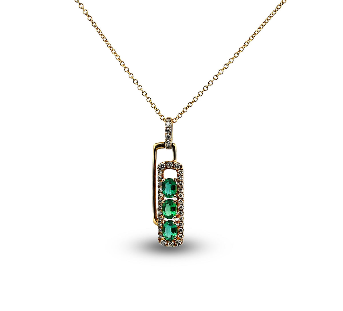 Gold necklace with a pendant featuring green gemstones on a white background