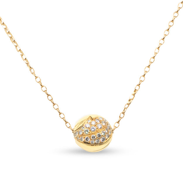 Gold necklace with a round, diamond-studded pendant on a white background