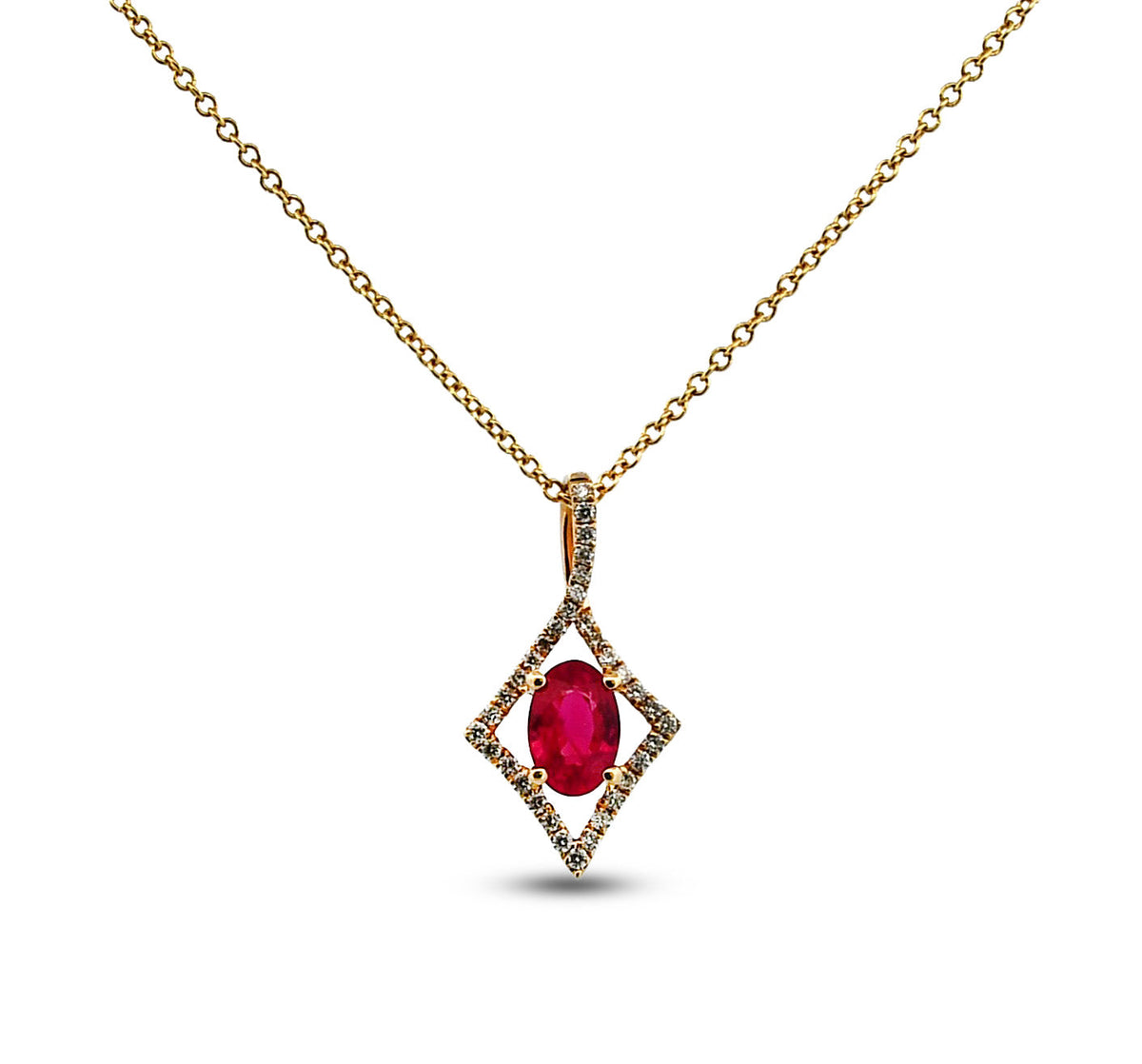 Gold necklace with a red gemstone pendant on a white background