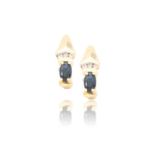 Gold earrings with blue gemstones on a white background