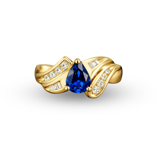Gold ring with a blue gemstone and diamond accents on a white background