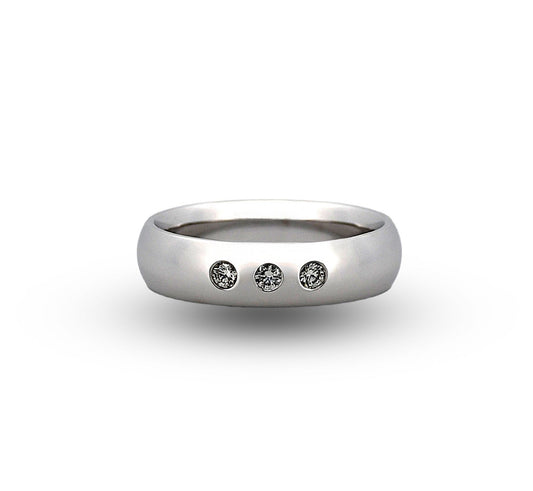 Silver ring with three diamonds on a white background