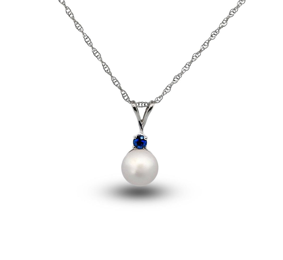 Pearl necklace with a blue gemstone on a white background