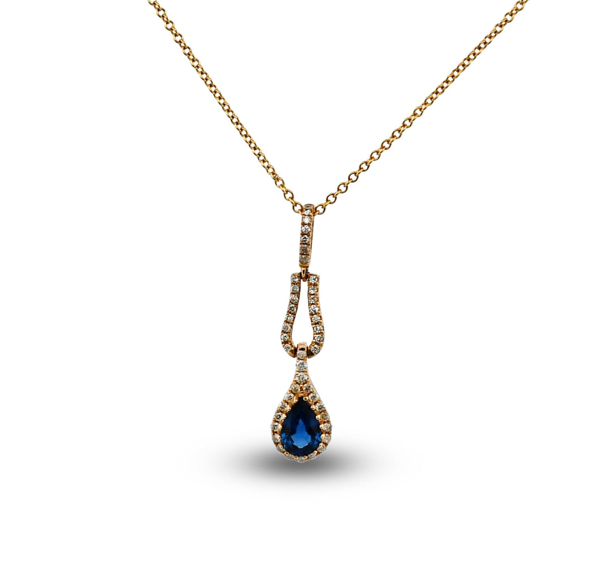 Gold necklace with a blue teardrop pendant on a white background