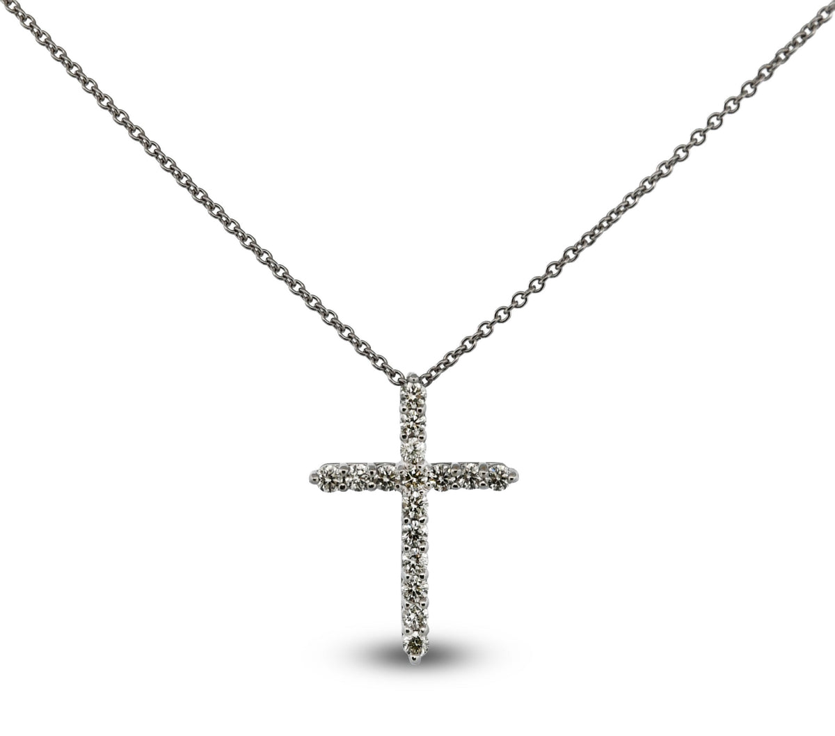 Silver cross necklace on a white background