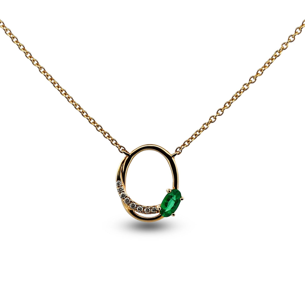 Gold necklace with a green gemstone pendant on a white background