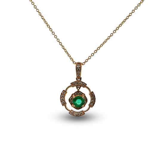Gold necklace with a green gemstone pendant on a white background