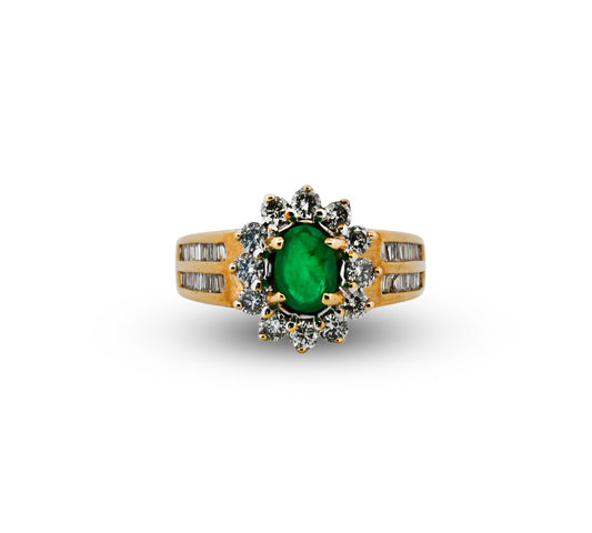 Gold ring with a green gemstone and diamond accents on a white background
