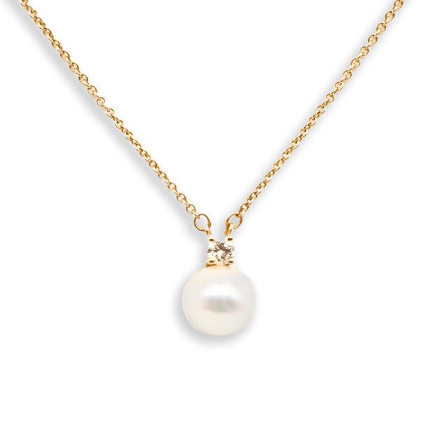 Pearl necklace with gold chain on a white background