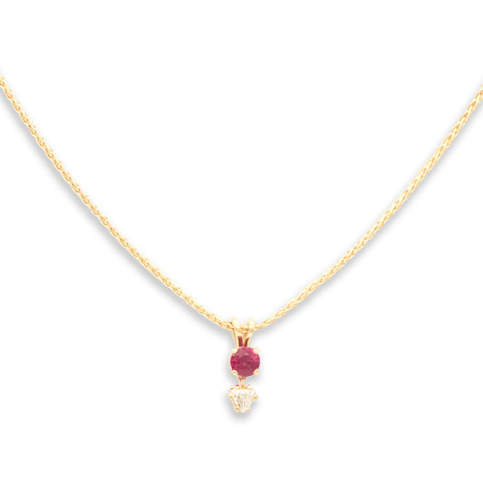 Gold necklace with a red gemstone pendant on a white background